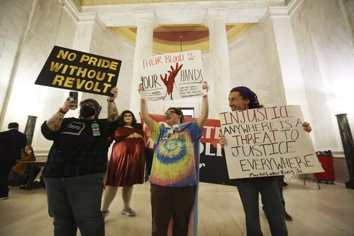 Protestors hold signs during a rally opposing HB2007 at the state capitol in Charleston, W.Va., on March 9, 2023. HB2007 would ban health care for trans children in the state. (AP Photo/Chris Jackson)