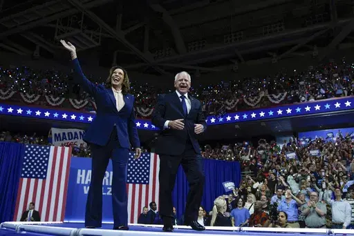 Democratic presidential nominee Vice President Kamala Harris and her running mate Minnesota Gov. Tim Walz arrive at a campaign rally in Philadelphia, Aug. 6, 2024. (AP Photo/Matt Rourke)