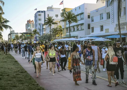 Tourists walk alongside Ocean Drive in Miami Beach, Fla., on March 21, 2021. A water main break in Miami Beach caused pressure to drop and forced officials to issue a boil water alert for the tourism hotspot on Friday, July 21, 2023. (Carl Juste/Miami Herald via AP, File)
