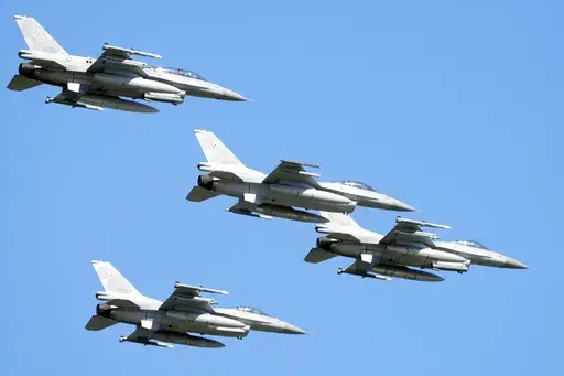 U.S. made F-16 fighter jets fly in the sky over Poland's capital as they take part in a massive military parade to celebrate the Polish Army Day, in Warsaw, Poland, Aug. 15, 2023. Ukraine has received the first tranche of western F-16 fighter jets that it has sought for months to be able to fight back against an onslaught of Russian missile strikes, a U.S. official confirmed to the Associated Press. Ukraine has been pushing to get Western F-16s for Ukraine for months, saying they were critically