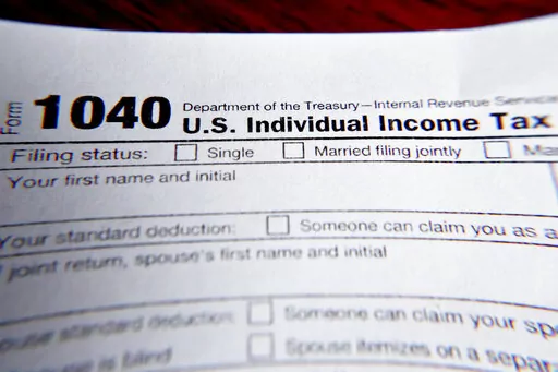 This Wednesday, Feb. 13, 2019 file photo shows part of a 1040 federal tax form printed from the Internal Revenue Service website, in Zelienople, Pa.  As the income tax filing deadline approaches, taxpayers will be facing unexpected tax situations brought about by the turbulent events of last year. Some taxpayers might get refunds and breaks they didn’t anticipate, while others could be paying more than they set aside.  (AP Photo/Keith Srakocic, File)