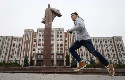 A boy runs past a statue of Soviet Union founder Vladimir Lenin in Tiraspol, the capital of the Russia-backed breakaway region of Transnistria, in Moldova on Nov. 1, 2021. Since Russia fully invaded Ukraine two years ago, a string of incidents in Transnistria have periodically raised the specter that European Union candidate Moldova could also be in Moscow's crosshairs. (AP Photo/Dmitri Lovetsky, File)
