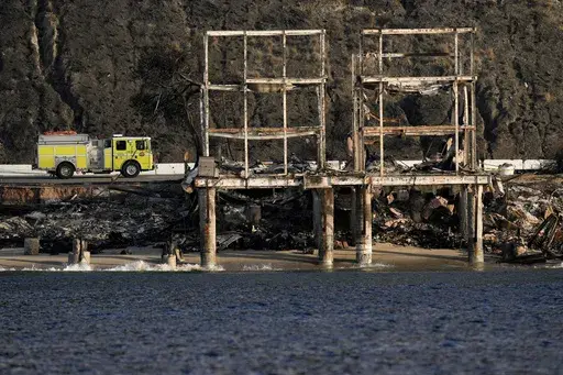 A firetruck is parked in front of a beachfront property damaged by the Palisades Fire Friday, Jan. 17, 2025 in Malibu, Calif. (AP Photo/Carolyn Kaster)