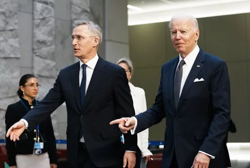 U.S. President Joe Biden, right, walks with NATO Secretary General Jens Stoltenberg prior to a group photo during an extraordinary NATO summit at NATO headquarters in Brussels, Thursday, March 24, 2022. As the war in Ukraine grinds into a second month, President Joe Biden and Western allies are gathering to chart a path to ramp up pressure on Russian President Vladimir Putin while tending to the economic and security fallout that's spreading across Europe and the world. (AP Photo/Thibault Camus)