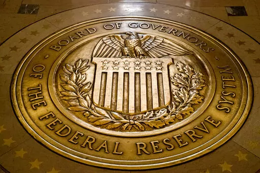 FILE- In this Feb. 5, 2018, file photo, the seal of the Board of Governors of the United States Federal Reserve System is displayed in the ground at the Marriner S. Eccles Federal Reserve Board Building in Washington. As the Federal Reserve continues to increase interest rates, borrowers may find that they’re paying more for their debts or perhaps missing out on opportunities to boost their savings with better rates. (AP Photo/Andrew Harnik, File)