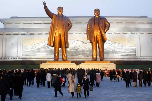 Citizens visit the bronze statues of their late leaders Kim Il Sung, left, and Kim Jong Il on Mansu Hill in Pyongyang, North Korea Thursday, Dec. 16, 2021, on the occasion of 10th anniversary of demise of Kim Jong Il. (AP Photo/Cha Song Ho)