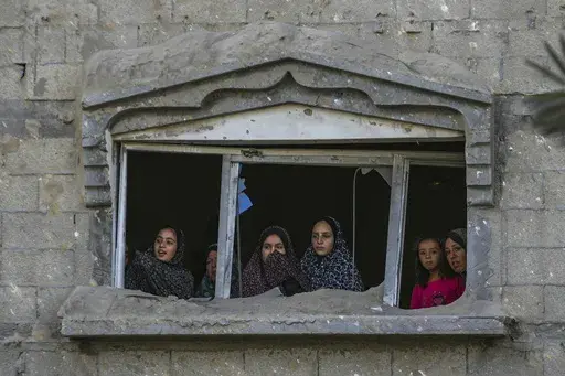 Palestinians look at the destruction after an Israeli airstrike on a crowded tent camp housing Palestinians displaced by the war in Muwasi, Gaza Strip, Sept. 10, 2024. (AP Photo/Abdel Kareem Hana, file)
