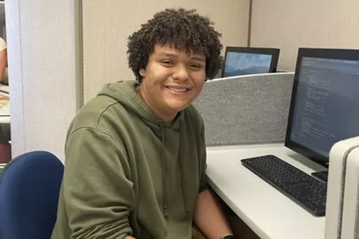 In the photo provided by Jaden Todd, Northern Virginia Community College student Jaden Todd, 21, sits a computer terminal on campus, Thursday, Nov 9, 2023, in Annandale, VA. Todd has plans to transfer to George Mason University to finish a degree in computer science. (Jaden Todd via AP)