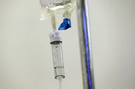 In this May 25, 2017 file photo, chemotherapy drugs are administered to a patient at a hospital in Chapel Hill, N.C. Scaling back treatment in some cancers — ovarian, esophageal and Hodgkin lymphoma — can make life easier for patients without compromising outcomes, doctors reported at the American Society of Clinical Oncology annual meeting in early June 2024. (AP Photo/Gerry Broome, File)