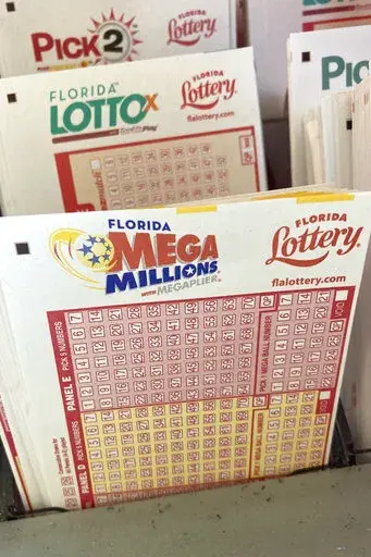 Mega Millions lottery playing slips are shown at a supermarket kiosk, Monday, Jan. 2, 2023, in Surfside, Fla. The jackpot for the Tuesday drawing is estimated at $785 million. (AP Photo/Wilfredo Lee)