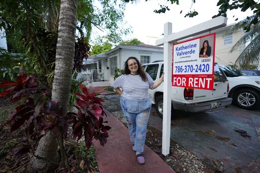 Krystal Guerra, 32, poses for a picture outside her apartment, which she has to leave after her new landlord gave her less than a month's notice that her rent would go up by 26%, Saturday, Feb. 12, 2022, in the Coral Way neighborhood of Miami. Guerra, who works in marketing while also pursuing a degree part-time, had already been spending nearly 50% of her monthly income on rent prior to the increase. Unable to afford a comparable apartment in the area as rents throughout the city have risen dra