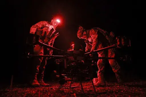 Ukrainian servicemen fix a bomb on a Vampire attack drone, on the front line near Chasiv Yar, Donetsk region, Ukraine, Monday, March 31, 2025, (Oleg Petrasiuk/Ukraine's 24th Mechanized Brigade via AP)