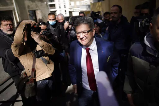 FILE- French far-left candidate Jean-Luc Melenchon leaves after voting in the first round of the presidential election at a polling station, April 10, 2022 in Marseille, southern France. A month before the first round of voting, the campaign for the 577 seats in France’s lower house of parliament has been brutal. After losing to Macron in the April presidential election, far-right leader Marine Le Pen now faces a challenge from her political nemesis, hard-left leader Jean-Luc Melenchon who has