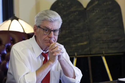 During his final week in office, Mississippi Republican Gov. Phil Bryant ponders a question in the state Capitol in Jackson, Miss., on, Jan. 8, 2020. Nancy New, who was convicted in 2022 in a welfare misspending case, said in a court filing Feb. 26, 2024, that Bryant told people in 2019, during his final weeks of office, that he had been offered a financial stake in a company that had received welfare money for its effort to develop a concussion drug. (AP Photo/Rogelio V. Solis, File)