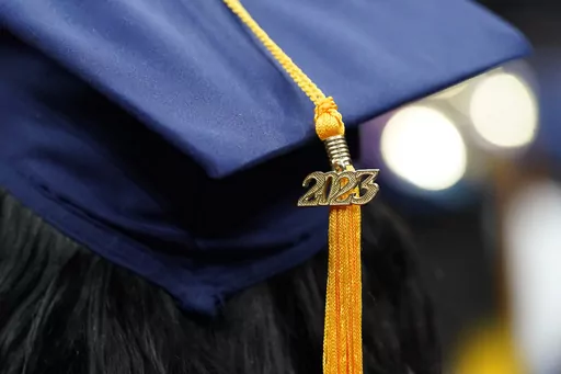A tassel with 2023 on it rests on a graduation cap as students walk in a procession for Howard University's commencement in Washington, Saturday, May 13, 2023. MBA grads say the investment in their degree was worth it, according to a 2022 survey by the Graduate Management Admission Council, an association of graduate business schools. (AP Photo/Alex Brandon, File)