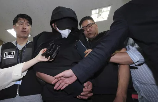 A man who opened an emergency exit door during a flight, arrives to attend an arrest warrant review at the Daegu District Court in Daegu, South Korea, Sunday, May 28, 2023. He told police that he felt suffocated and tried to get off the plane quickly as it approached landing, reports said Saturday. (Yun Kwan-shick/Yonhap via AP)