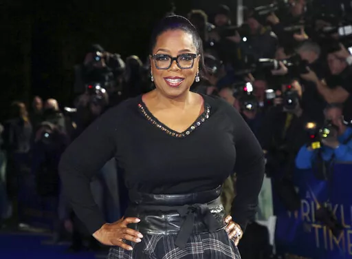 In this March 13, 2018, file photo, actress Oprah Winfrey poses for photographers upon arrival at the premiere of the film "A Wrinkle In Time" in London. Winfrey and the Smithsonian Channel are partnering up to highlight the racial disparities in the healthcare system through a new campaign and documentary. The network revealed on Thursday the Color of Care campaign to create a solution toward health equity. The campaign will follow the premiere of Winfrey’s “The Color of Care” documentary