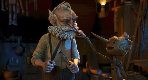This image released by Netflix shows Gepetto, voiced by David Bradley, left, and Pinocchio, voiced by Gregory Mann, in a scene from "Guillermo del Toro's Pinocchio." (Netflix via AP)