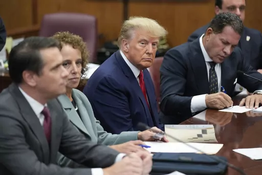 Former President Donald Trump sits at the defense table with his legal team in a Manhattan court, April 4, 2023, in New York. Federal Judge Alvin K. Hellerstein in New York City is set to hear arguments June 27 over whether the state criminal hush money prosecution of former President Donald Trump can be moved to federal court. He's unlikely to immediately rule. (AP Photo/Seth Wenig, Pool, File)
