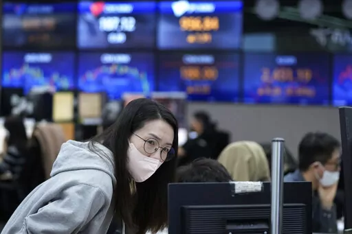 A currency trader watches monitors at the foreign exchange dealing room of the KEB Hana Bank headquarters in Seoul, South Korea, Friday, Nov. 18, 2022. Asian stocks were mixed Friday after Wall Street declined following indications the Federal Reserve might raise interest rates higher than expected to cool inflation. (AP Photo/Ahn Young-joon)