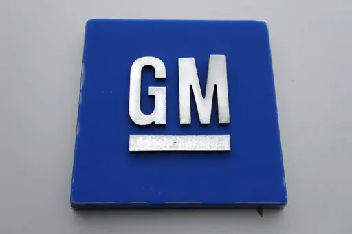 The General Motors logo is displayed outside the General Motors Detroit-Hamtramck Assembly plant, Jan. 27, 2020, in Hamtramck, Mich. General Motors is offering buyouts to most of its U.S. salaried workforce and some global executives in an effort to trim costs as it makes the transition to electric vehicles. (AP Photo/Paul Sancya, File)