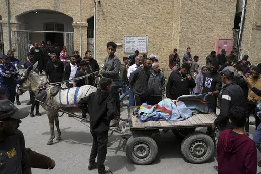 Palestinians carry the bodies of their relatives who were killed in an Israeli airstrike in Shijaiyah neighborhood, as they brought to the Baptist Hospital in Gaza City on Wednesday, April 9, 2025. (AP Photo/Jehad Alshrafi)