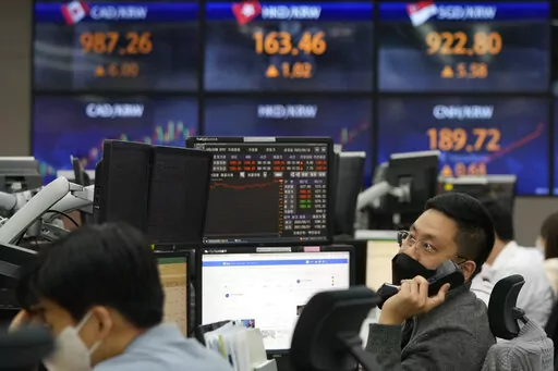 A currency trader watches monitors at the foreign exchange dealing room of the KEB Hana Bank headquarters in Seoul, South Korea, Thursday, May 12, 2022. Shares fell in Asia on Thursday after the release of worse U.S. inflation data than expected sparked heavy selling of technology stocks on Wall Street. (AP Photo/Ahn Young-joon)