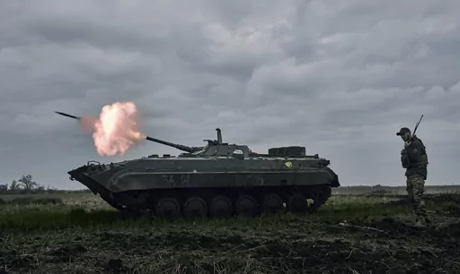A Ukrainian APC fires towards Russian positions near Avdiivka, in the Donetsk region, Ukraine, Friday, April 28, 2023. A dayslong attempt by Russian forces to storm a strategically important city in eastern Ukraine appears to be running out of steam, Kyiv officials claimed Monday, Oct. 16, 2023 as the Kremlin’s war entered its 600th day. (AP Photo/Libkos, File)