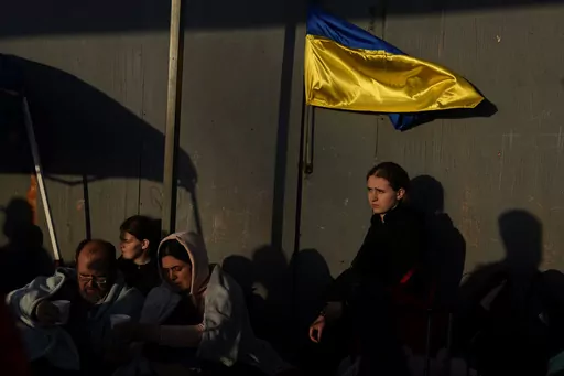 Ukrainian refugees wait near the U.S. border in Tijuana, Mexico, April 4, 2022. A month after Russia invaded Ukraine, refugees started showing up to the U.S.-Mexico border. Roughly 1,000 Ukrainians a day flew to Tijuana on tourist visas, desperate to get into the country. The volume was overwhelming the nation’s busiest border crossing in San Diego. Just over the border in Tijuana Mexico, thousands of Ukrainians slept in a municipal gym hoping to for a chance to get across. (AP Photo/Gregory B