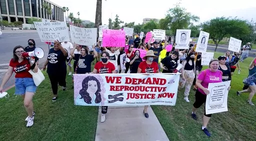 Thousands of protesters march around the Arizona Capitol in protest after the Supreme Court decision to overturn the landmark Roe v. Wade abortion decision Friday, June 24, 2022, in Phoenix. The U.S. Supreme Court ruling overturning Roe v. Wade has legal advocates, prosecutors and residents of red states facing a legal morass created by decades of often conflicting anti-abortion legislation. In Arizona, Republicans are fighting among themselves over whether a 121-year-old anti-abortion law that 