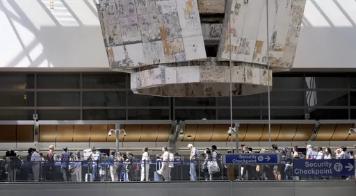 Travelers stand in line at the Tom Bradley International Terminal at LAX on Wednesday, Aug. 30, 2023, in Los Angeles. With Labor Day weekend just days away, airports and roadways are expected to be busy as tens of thousands of Southern Californians travel out of town. (Dean Musgrove/The Orange County Register via AP)