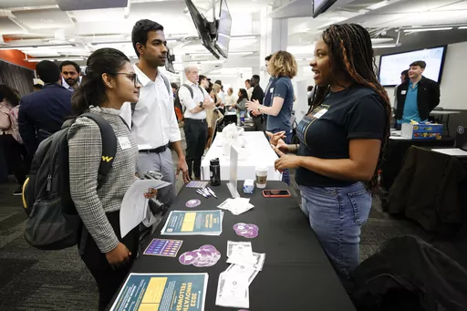 Georgia State University students Kavita Javalagi, left, and Gana Natarajan, second from left, speak with Shetundra Pinkston, during the Startup Student Connection job fair, Wednesday, March 29, 2023, in Atlanta. For the thousands of workers who'd never experienced upheaval in the tech sector, the recent mass layoffs at companies like Google, Microsoft, Amazon and Meta came as a shock. Now they are being courted by long-established employers whose names aren't typically synonymous with tech work