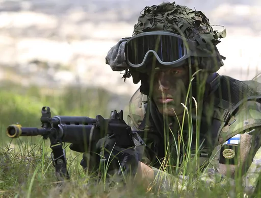 A Finnish soldier participates in the amphibious operations as part of NATO sea exercises BALTOPS 2015 in Ustka, Poland, on June 17, 2015. NATO Secretary-General Jens Stoltenberg said Monday Finland will become the 31st member of the world's biggest military alliance on Tuesday, prompting a warning from Russia that it would bolster its defenses near their joint border if NATO deploys any troops in its new member. (AP Photo/Czarek Sokolowski, File)