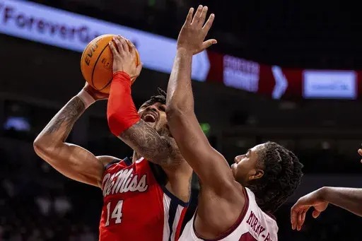 Mississippi guard Dre Davis (14) shoots on South Carolina forward Collin Murray-Boyles, right, during the first half of an NCAA college basketball game Wednesday, Feb. 12, 2025, in Columbia, S.C. (AP Photo/Scott Kinser)