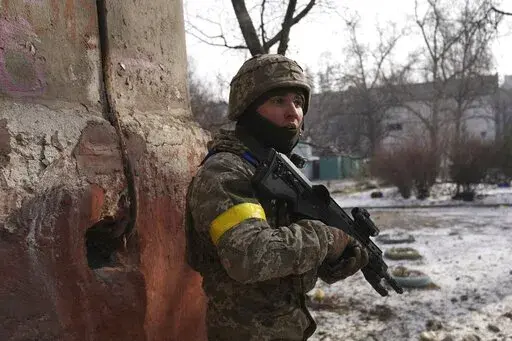 A Ukrainian serviceman guards his position in Mariupol, Ukraine, Saturday, March 12, 2022. Ukraine’s military says Russian forces have captured the eastern outskirts of the besieged city of Mariupol. In a Facebook update Saturday, the military said the capture of Mariupol and Severodonetsk in the east were a priority for Russian forces. Mariupol has been under siege for over a week, with no electricity, gas or water. (AP Photo/Evgeniy Maloletka)