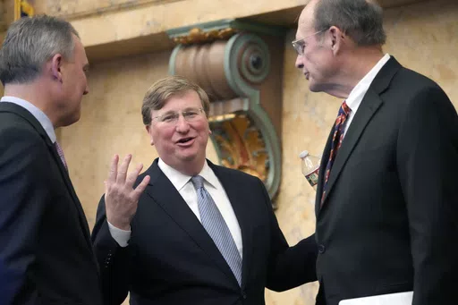 Mississippi Republican Gov. Tate Reeves, center, confers with Mississippi House Speaker Jason White, R-West, left, and Republican Lt. Gov. Delbert Hosemann, after his State of the State address to a joint session of the Mississippi State Legislature, Monday, Feb. 26, 2024, at the state Capitol in Jackson, Miss. Reeves signed legislation Wednesday, May 8, 2024, to change Mississippi's school funding formula beginning July 1, 2024. (AP Photo/Rogelio V. Solis, File)