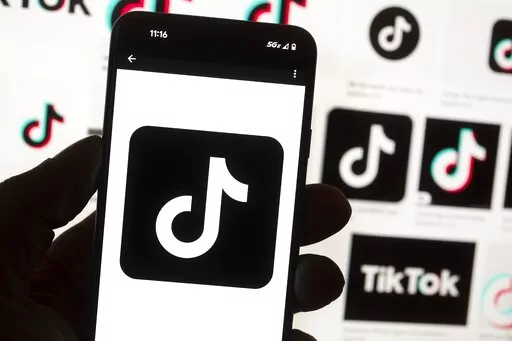The TikTok logo is seen on a cell phone on Oct. 14, 2022, in Boston. TikTok will be banned from all Mississippi-issued government devices and the state’s network, Gov. Tate Reeves announced Wednesday, Jan. 11, 2023, in a letter to department and agency heads. Reeves says he issued the directive to safeguard sensitive information from the popular social media app. (AP Photo/Michael Dwyer, File)