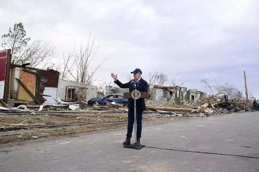 President Joe Biden speaks after surveying storm damage from tornadoes and extreme weather in Dawson Springs, Ky., Dec. 15, 2021. Biden faces a steep path to achieve his ambitious goal of slashing planet-warming greenhouse gas emissions in half by 2030. His $2 trillion Build Back Better plan contains $550 billion in spending and tax credits aimed at promoting clean energy.  (AP Photo/Andrew Harnik, File)