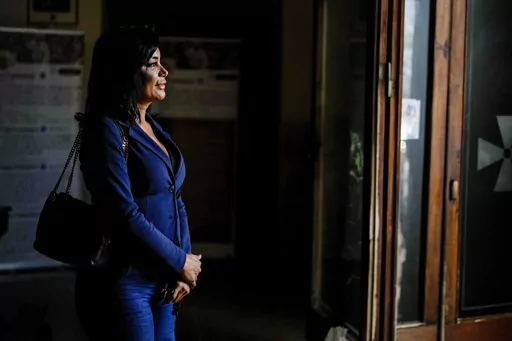 Carla Segovia, a transgender woman from Argentina, walks out of the Beata Vergine Immacolata parish church in Torvaianica, Italy, Thursday, Nov. 16, 2023. Pope Francis’ recent gesture of welcome for transgender Catholics has resonated strongly in this working class, seaside town south of Rome, where a community of trans women has found help and hope through a remarkable friendship with the pontiff forged during the darkest times of the pandemic. (AP Photo/Andrew Medichini)