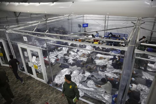Children lie inside a pod at the main detention center for unaccompanied children in the Rio Grande Valley run by U.S. Customs and Border Protection (CBP), in Donna, Texas, March 30, 2021. A company that provides services for immigrants in federal detention was ordered Tuesday, April 2, 2024, to pay more than $811 million in restitution and penalties in a lawsuit alleging it used deceptive and abusive tactics. (AP Photo/Dario Lopez-Mills, Pool, File)