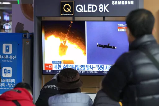 People watch a TV showing file images of North Korea's missile launch during a news program at the Seoul Railway Station in Seoul, South Korea, Tuesday, Jan. 25, 2022. North Korea on Tuesday test-fired two suspected cruise missiles in its fifth round of weapons launches this month, South Korean military officials said, as it displays its military might amid pandemic-related difficulties and a prolonged freeze in nuclear negotiations with the United States. The Korean letters read: "North Korea f