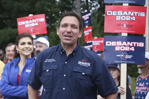 Republican presidential candidate and Florida Gov. Ron DeSantis and his wife Casey, walk in the July 4th parade, July 4, 2023, in Merrimack, N.H. DeSantis is defending an anti-LGBTQ video his campaign shared online that attacks rival Donald Trump for his past support of gay and transgender people, despite some of his fellow Republicans calling it homophobic. (AP Photo/Reba Saldanha, File)