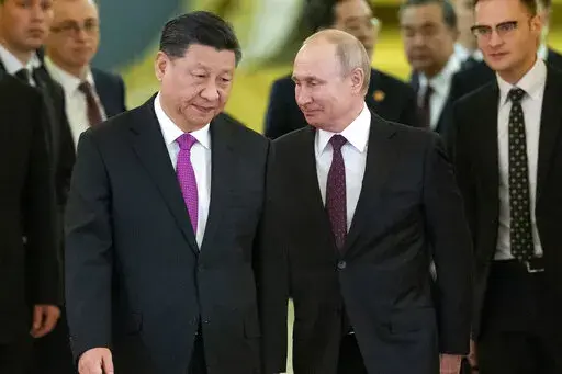 Chinese President Xi Jinping, center left, and Russian President Vladimir Putin, center right, enter a hall for talks in the Kremlin in Moscow, Russia, June 5, 2019. Amid the soaring tensions over Ukraine, President Vladimir Putin is heading to Beijing on a trip intended to help strengthen Russia's ties with China and coordinate their policies amid Western pressure. (AP Photo/Alexander Zemlianichenko, Pool, File)