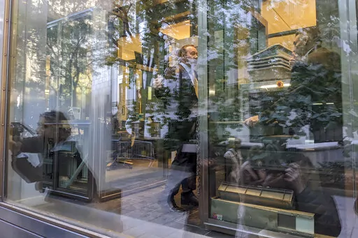 Video journalists and photographers are reflected in the glass as they cover the arrival of actor Kevin Spacey for a civil case at a federal courthouse in lower Manhattan in New York on Thursday, Oct. 20, 2022. (AP Photo/Ted Shaffrey)