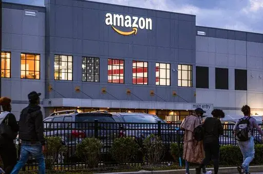 People arrive for work at the Amazon distribution center in the Staten Island borough of New York, Monday, Oct. 25, 2021.  An independent group formed by former and current Amazon workers are trying to unionize a company warehouse in New York City. If successful, the effort at the Amazon fulfillment center in Staten Island could lead to the first unionized Amazon facility in the U.S. (AP Photo/Craig Ruttle, File)