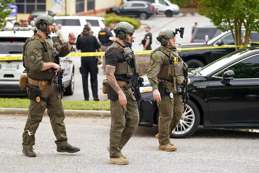 Authorities stage outside Columbiana Centre mall in Columbia, S.C., following a shooting, Saturday, April 16, 2022. (AP Photo/Sean Rayford)