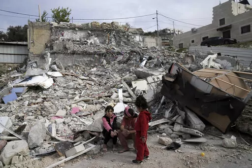 Girls from the Matar family sit near the rubble of their home that housed 11 people before it was demolished by Israeli authorities in the Jabal Mukaber neighborhood of east Jerusalem, Sunday, Jan. 29, 2023. For many Palestinians, the accelerating pace of home demolitions is part of Israel's new ultranationalist government's broader battle for control of east Jerusalem, claimed by the Palestinians as the capital of their future state. Israel says it is simply enforcing building regulations. (AP 
