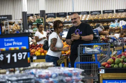 Shoppers pause in the produce section at a Walmart Superstore in Secaucus, New Jersey, July 11, 2024. (AP Photo/Eduardo Munoz Alvarez, File)