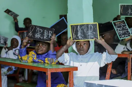 Boys sit in a classroom at Nouadhibou's Organization for the Support of Migrants and refugees, Mauritania, Tuesday, Jan. 7, 2025. (AP Photo/Khaled Moulay)