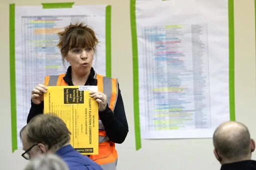 Kimberly Zapata, deputy director of the Milwaukee Election Commission, instructs workers processing ballots, Tuesday, April 5, 2022 at the central counting facility in Milwaukee, Wis. Zapata has been fired after sending falsely obtained military absentee ballots to the home of a Republican state lawmaker who has been an outspoken critic of how the 2020 election was administered, the city's mayor said Thursday, Nov. 3, 2022. (Mark Hoffman/Milwaukee Journal-Sentinel via AP)
